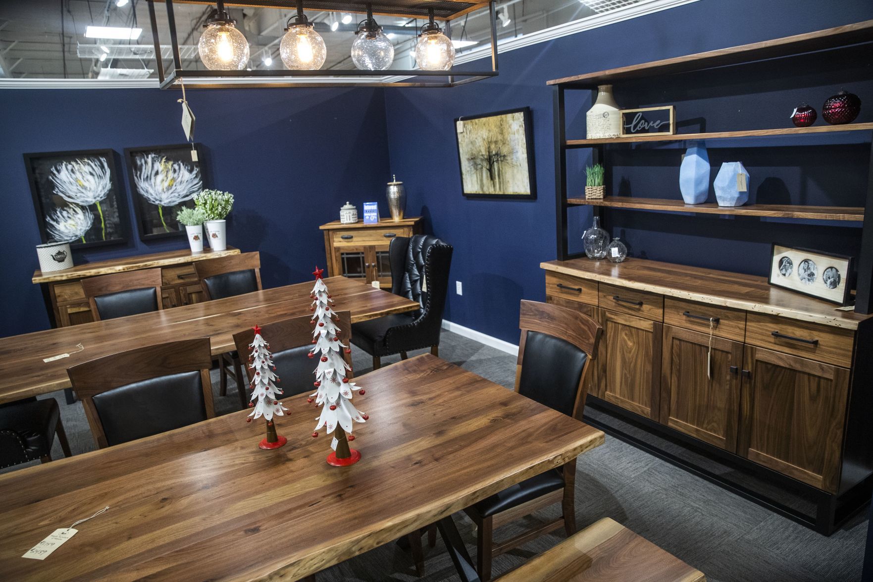 Dining room decor and furniture is displayed on the showroom floor.